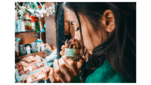 Woman smelling pack of dried roses.