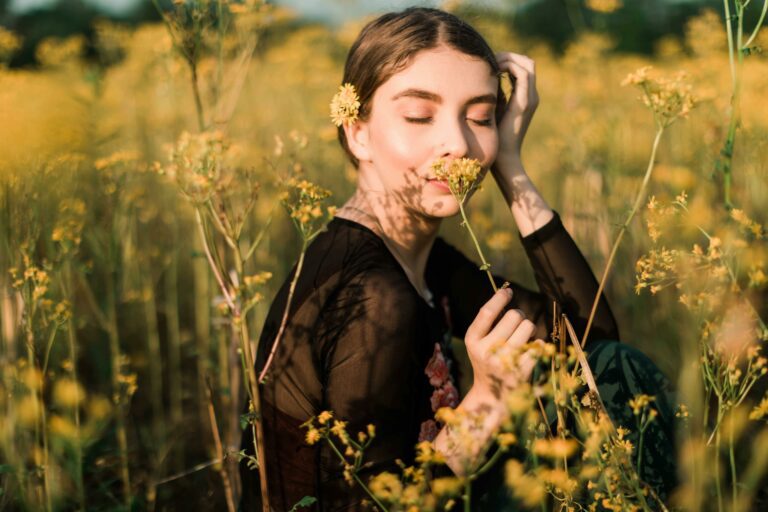 Photo of a woman smelling a plant