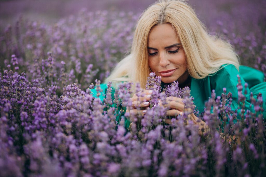 Woman smelling flowers rich in terpenes.